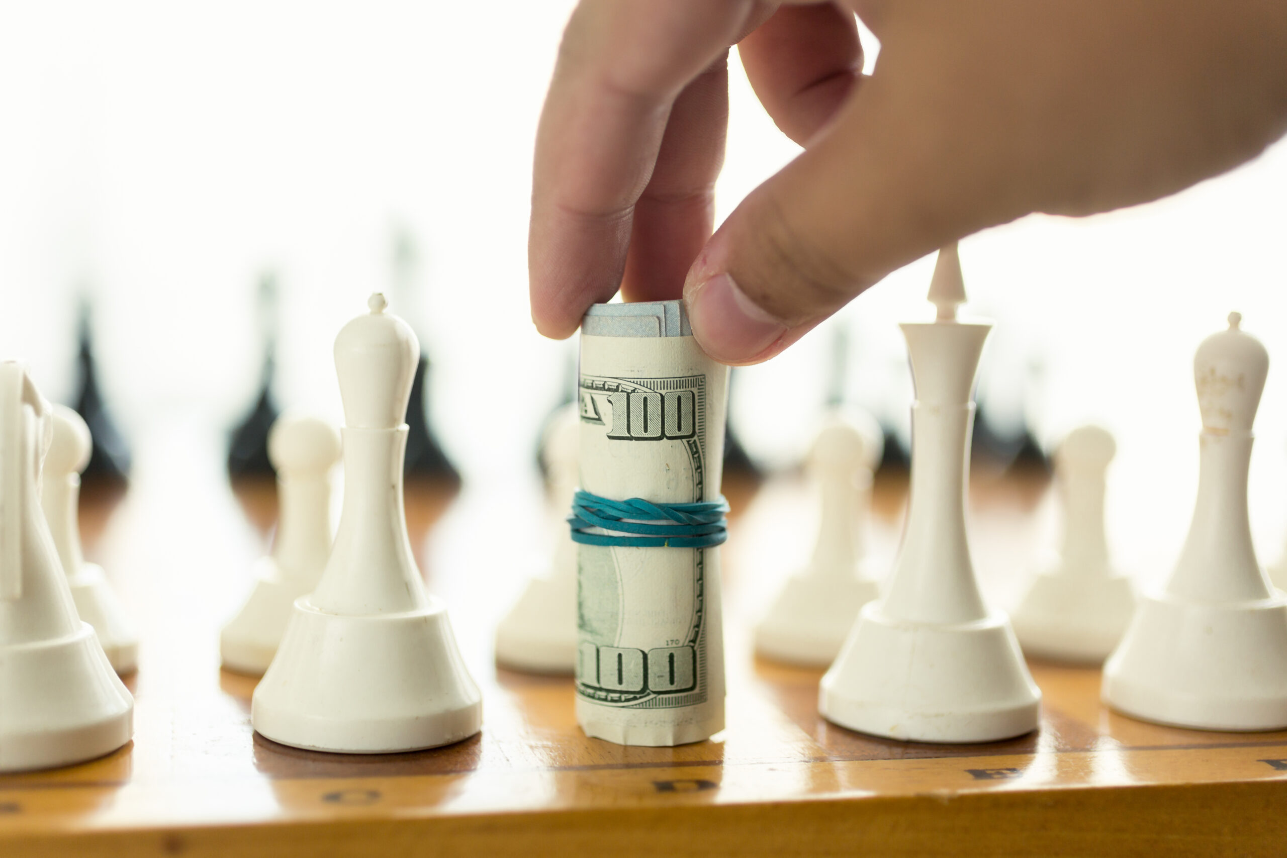 Real estate investing in Clermont FL visualized through a chessboard strategy with money as the key player.